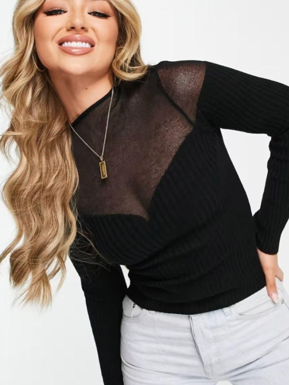 Black ribbed knit long sleeve top with sheer mesh panel
